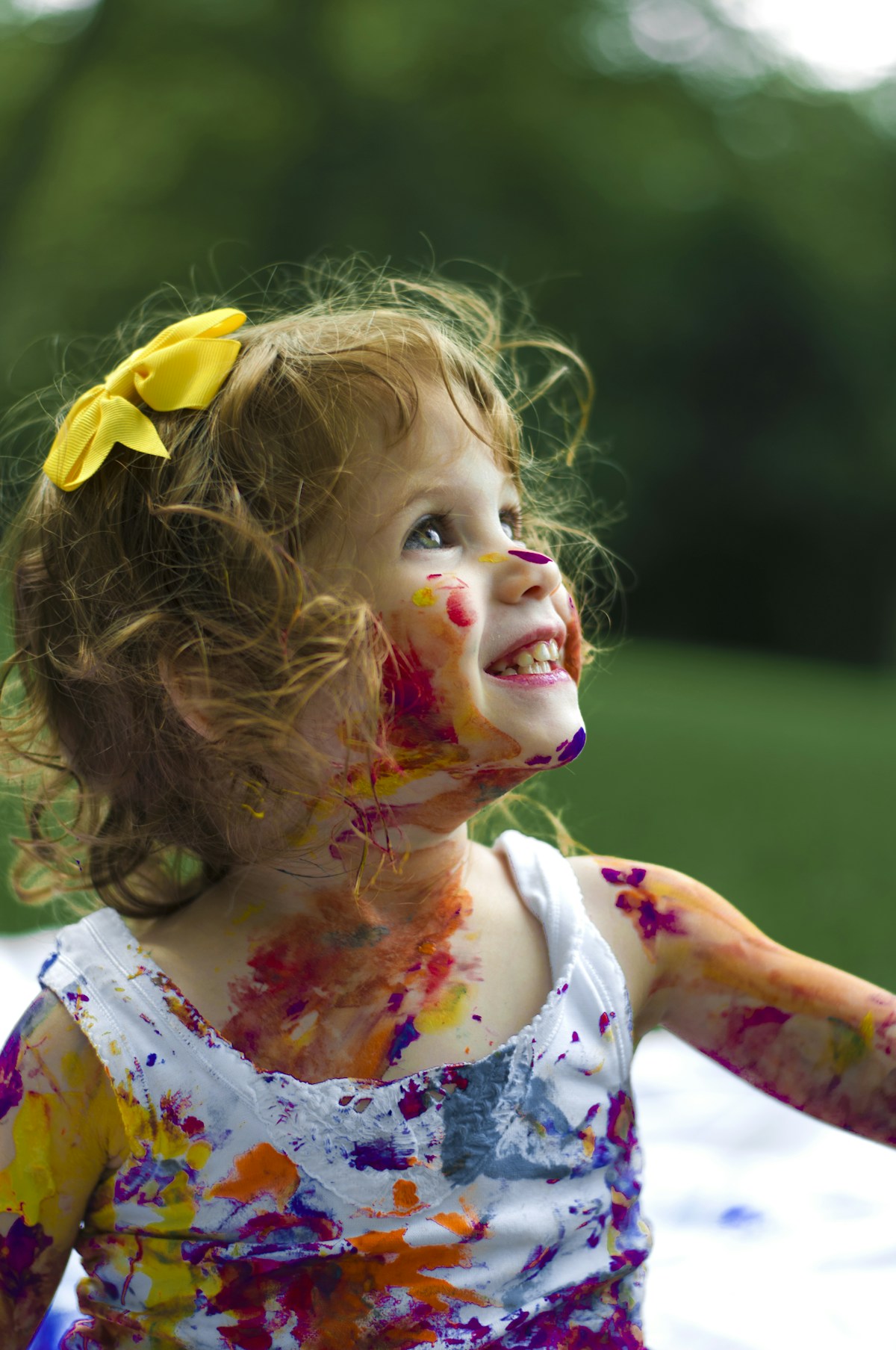 A young child enjoying a colorful art activity